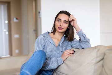 Fototapeta premium Young pretty woman resting on couch at home