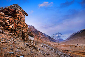 View of Mount Everest from the RongPu Monastery, at the Everest Base Camp in Tibet, against a cold morning sky.