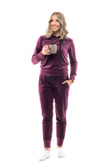 Happy confident young pretty woman in home comfy clothes with coffee or tea mug smile and looks up. Full body length isolated on white background.