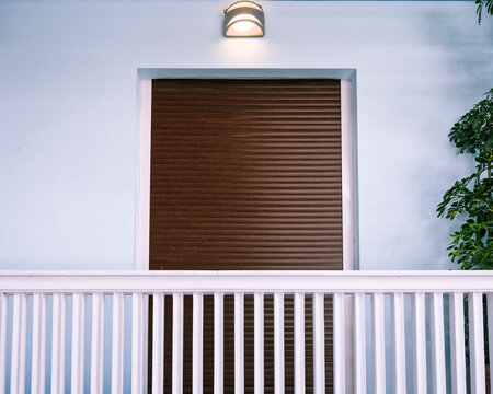 Contemporary House Light Blue Front And Balcony Natural Wood Roller Shutters Door