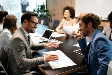 Happy diverse business colleagues meeting, working in modern office