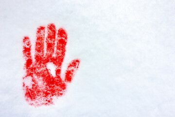 Red handprint on snow. Blood in the snow.