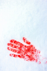 Red handprint on snow. Blood in the snow.