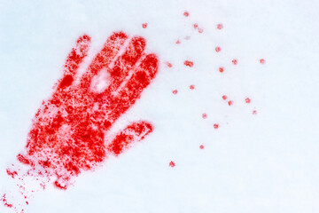 Red handprint on snow. Blood in the snow.
