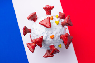 Coronavirus pandemic in France. 3D model of Covid-19 virus on flag of France