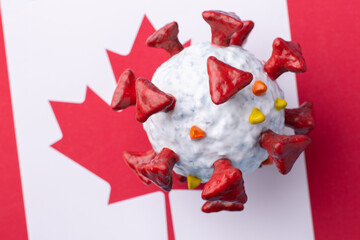 Coronavirus in Canada. Hand made Covid-19 model on a Canada flag