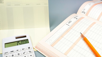 Close up of household account book, bankbook and calculator. Concept of making an economic plan.