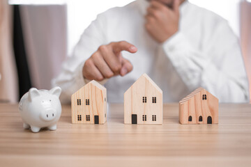 Business men are thinking hard about choosing a home and saving money. He is planning a future for his family and choosing the best money saving ideas. Energy saving financial analysis