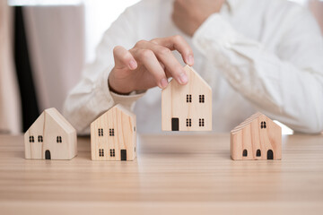 Business men are thinking hard about choosing a home and saving money. He is planning a future for...