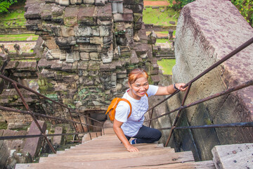 Angkor Wat Siem Reap Cambodia  Southeast Asia Tour
Thai Lady climbing  in the temple ruin of Angkor...