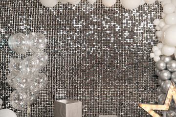 Festive silver background mosaic with light spots with silver glittering decorations. Disco balls...