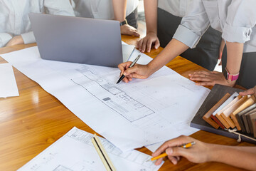 Architects working with blueprints in the office.