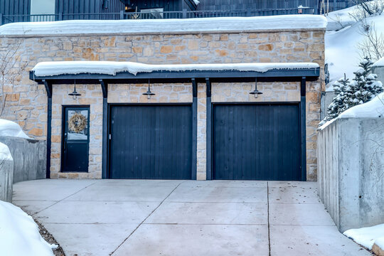 Front View Of A Luxury House With Glass Paned Front Door And Two Car Garage