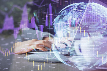 Double exposure of woman hands typing on computer and forex chart hologram drawing. Stock market invest concept.