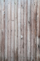 Fototapeta na wymiar Aged brown wooden fence texture. Old English textured vertical wood wall surface background pattern with mossy planks and nails