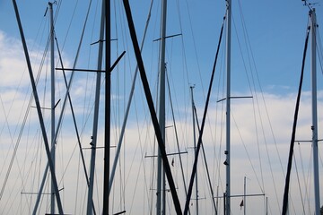 close up of various masts of sailing ships