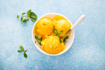 Mango ice cream, sorbet in a plate on a concrete background