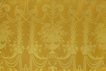 Gold fabric with gold embroidery isolated to create a noble background