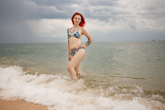 red haired girl rest on the sea shore