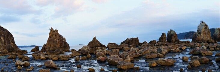 Hashikuiiwa Rocks in a row towering over the seashore from Kushimoto heading towards Oshima in Wakayama, Japan - 橋杭岩　串本町　和歌山県　日本　パノラマ