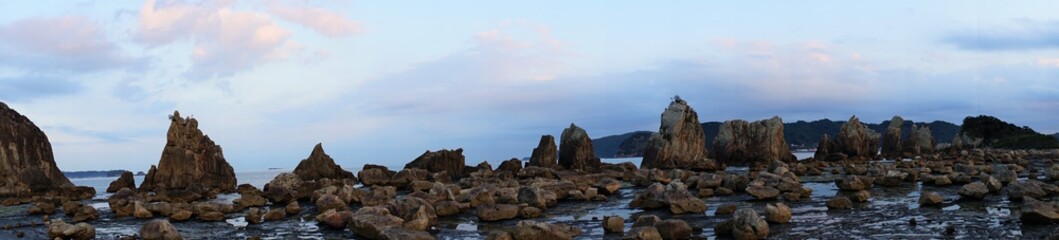 Hashikuiiwa Rocks in a row towering over the seashore from Kushimoto heading towards Oshima in Wakayama, Japan - 橋杭岩　串本町　和歌山県　日本　パノラマ