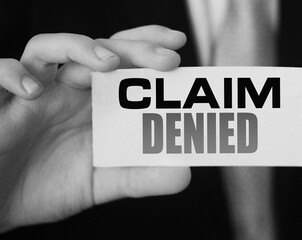 Businessman shows a card with text Claim Denied . Injury claim insurance concept