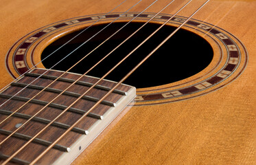 Close up of wooden acoustic guitar strings