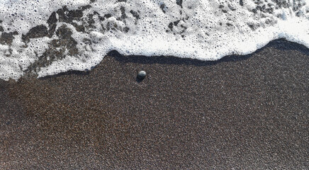Black sand close up in the shore