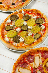 Different slices of pizza with different toppings on a white background. Cut into slices delicious fresh pizza. Tasty pizza on white.