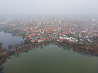 Aerial view of Dobris above pond Papez in fog