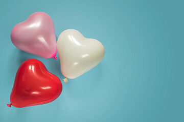 Heart shaped baloons on blue background