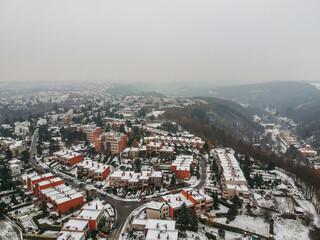 Fototapeta na wymiar Aerial view of row houses in residential area of Baba in Dejvice in witner with snow on the flat roofs