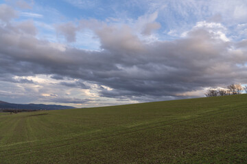 Panorama of rain clouds over a grassy meadow