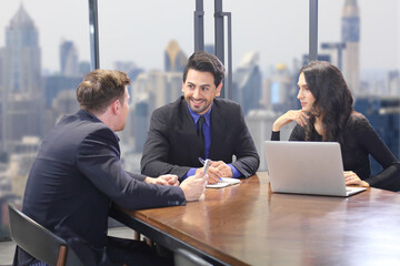 Caucasian businessman is showing his coworker new strategic planning for next year in company executive meeting with skyline cityscape view on the background