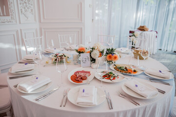 wedding table in a restaurant with decor and food