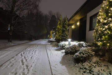 Houses in the suburbs. Winter in Finland Street and houses covered with beautiful snow Evening photo