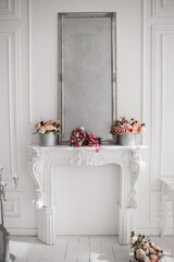 beautiful decorative fireplace with mirror and flowers