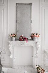 beautiful decorative fireplace with mirror and flowers