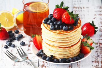 A stack if home-made pancakes with berry