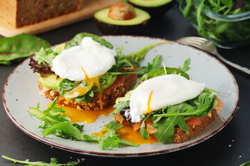 Homemade sandwiches with salmon, avocado and poached eggs