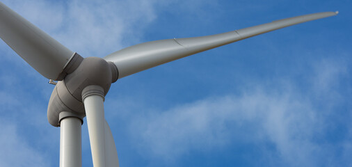 Detail of wind turbine against blue sky, clean energy generator wind turbine in wind farm