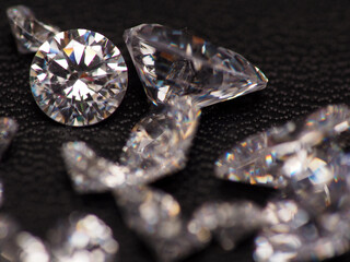 Close up shoot of group of sparkling diamonds, shoot on black leather as background