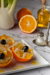 Fennel salad with orange and olives on a white backgrou d