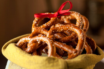Bretzel in a yellow bowl with a red ribbon