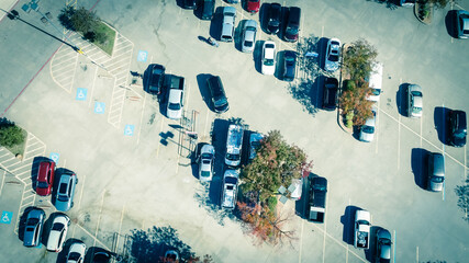 Aerial view disable parking signs at grocery store parking lot with colorful autumn leaves near Dallas, Texas, USA