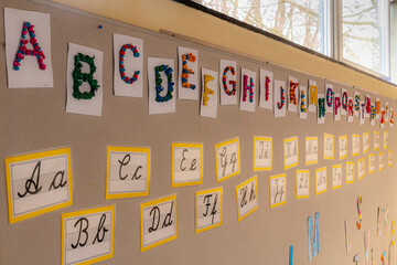 Colored letters in block and cursive on the wall of a primary school