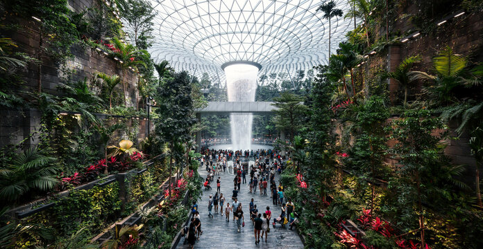 Panoramic view, Tourists visit The HSBC Rain Vortex, world's largest indoor waterfall at 40m tall, in Jewel Changi Airport, new tourist attraction of Changi Airport in Singapore