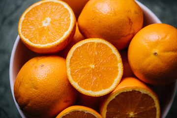 fresh cut  oranges  in a white bowl