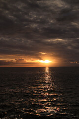 Obraz premium Copper tones in the sea during sunset. Fañabé. Tenerife. Canary Islands. Spain
