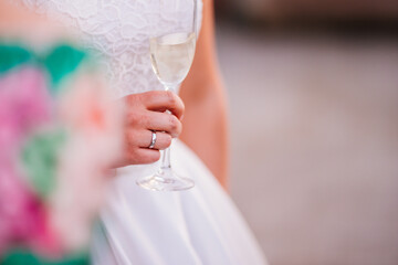 Bride holding a glass of champagne on a wedding day